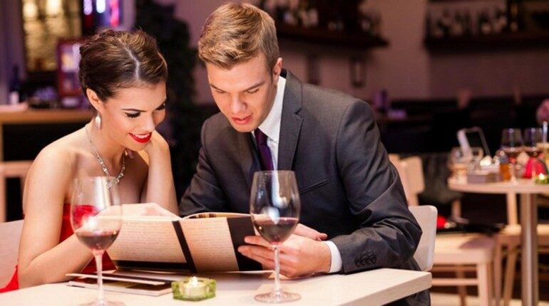 романтический ужин в ресторане, парень с девушкой изучают меню в ресторане